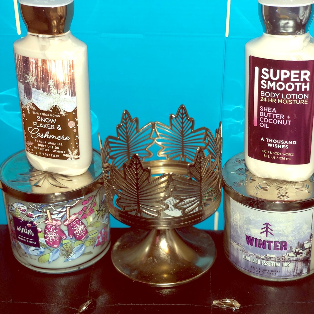 Two lotions and two big candles and candle holder